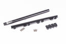 Stock photo of a black, metal Radium Fuel Rail with fittings and mounting hardware.