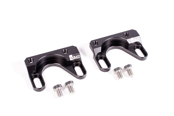 Stock photo of a black, metal Radium Fuel Rail Adapter for Subaru EJ207 and 2.5I EJ253 engines.