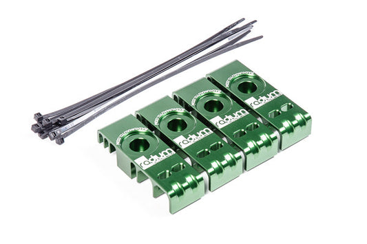 Stock photo of a green, metal Radium MKIV Supra Fuel and Brake Line Retainer Kit