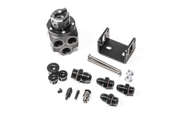 Stock photo of a black, metal Radium Multiport Regulator kit. 