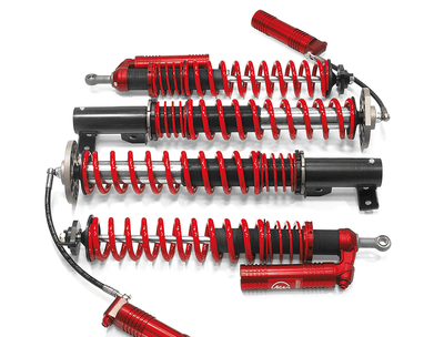 Samsonas stainless steel rally coilovers for BMW E36 and E46 with red springs and external reservoirs.