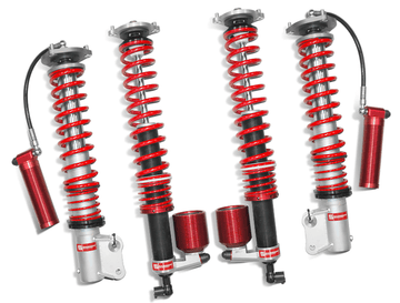 Samsonas stainless steel rally coilovers for Mitsubishi EVO X with red springs and external reservoirs.