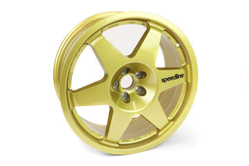 Gold Speedline Corse 2013C wheel with black branding for rally applications. 
