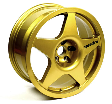 Gold Speedline Corse 2110 wheel with black branding for rally applications. 